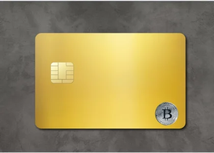 cartão cripto dourado com símbolo do bitcoin representando pagamento digital com criptomoedas e stablecoins