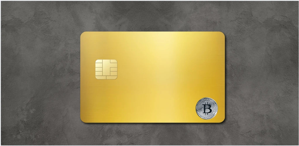 cartão cripto dourado com símbolo do bitcoin representando pagamento digital com criptomoedas e stablecoins