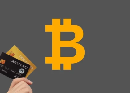 cartão de crédito cripto ao lado do símbolo do Bitcoin representando pagamentos com criptomoedas em viagens e gastos internacionais