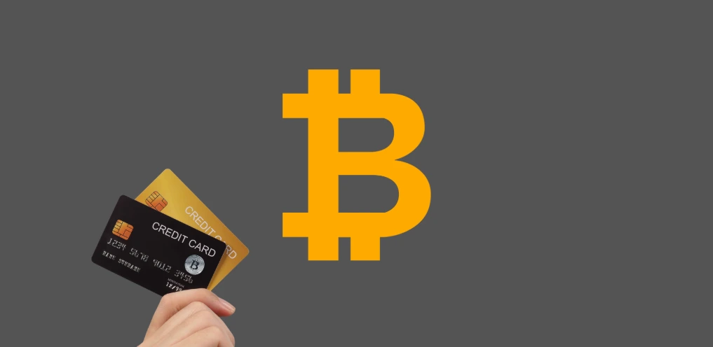 cartão de crédito cripto ao lado do símbolo do Bitcoin representando pagamentos com criptomoedas em viagens e gastos internacionais